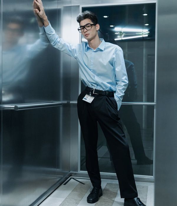 Confident middle-aged man engineer in formal business attire standing in office environment
