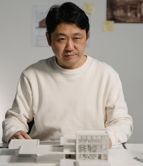 Focused man engineer examining technical blueprints and electrical diagrams